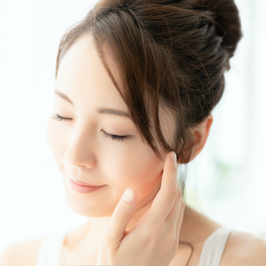 asian woman with clear and healthy skin because of korean skincare routine