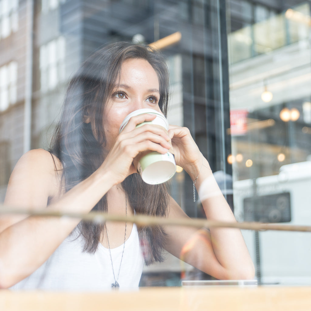 Asian woman drinking coffee